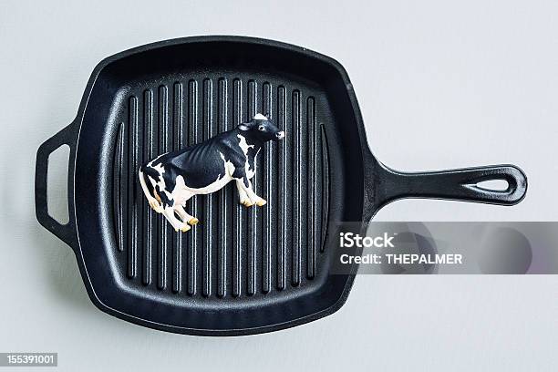 Cow Toy On Cast Iron Pan Stock Photo - Download Image Now - Animal, Cast Iron, Cattle