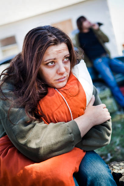 istock Homeless woman hugging a pillow looking worried 155391279