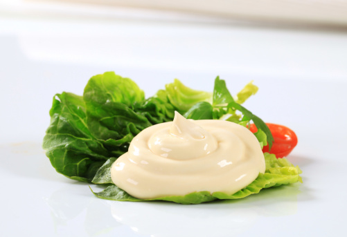 Leaf of lettuce with tomato and mayonnaise
