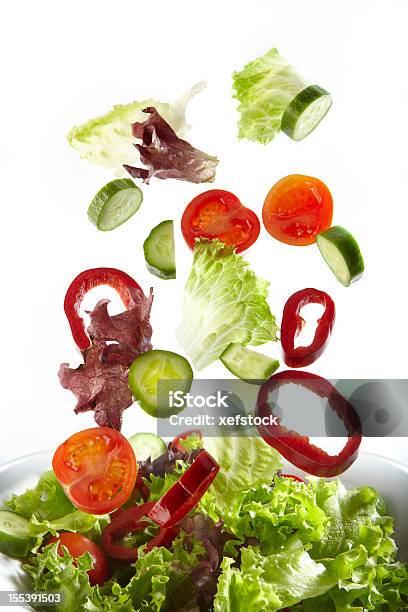 Fresh Salad Filled With Lettuce And Tomato Stock Photo - Download Image Now - Salad, Falling, White Background