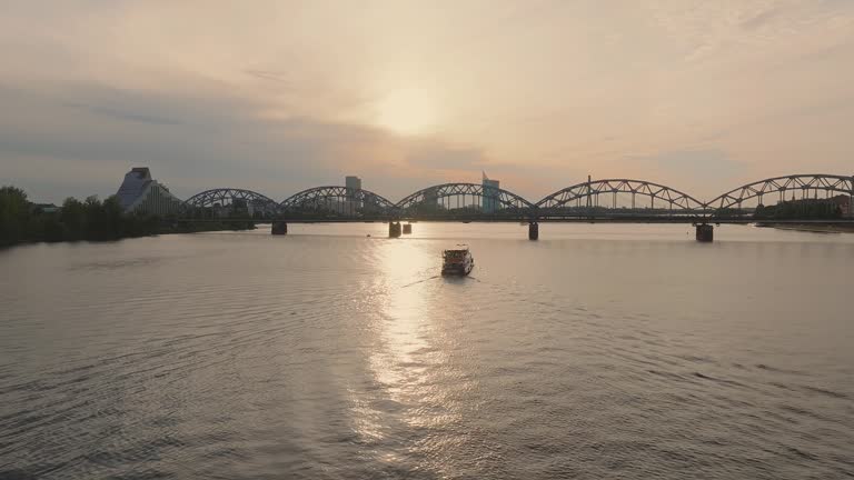 Small cruise ship or a speed boat cruising down the Daugava river in Riga