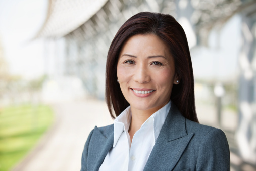 Portrait of a beautiful Asian businesswoman smiling. Horizontal shot.