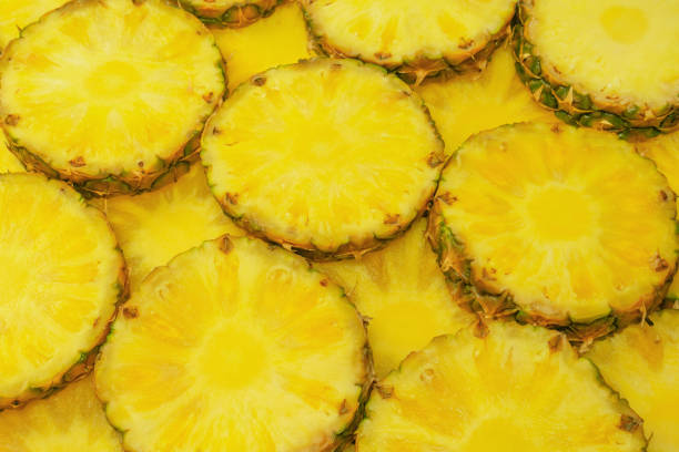 istock Pineapple juicy yellow slices as a background. 1553920109
