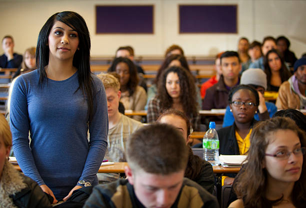 University student standing in lecture room stock photo