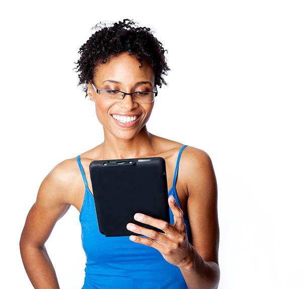 istock smiling woman reading from digital tablet 155392394