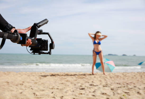 istock Live streaming or Vidio shooting woman with bikini on beach theme summer vacation 1553926450