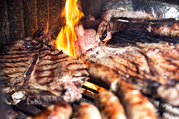 istock T-Bone Steak and Sausages on the BBQ 155392702