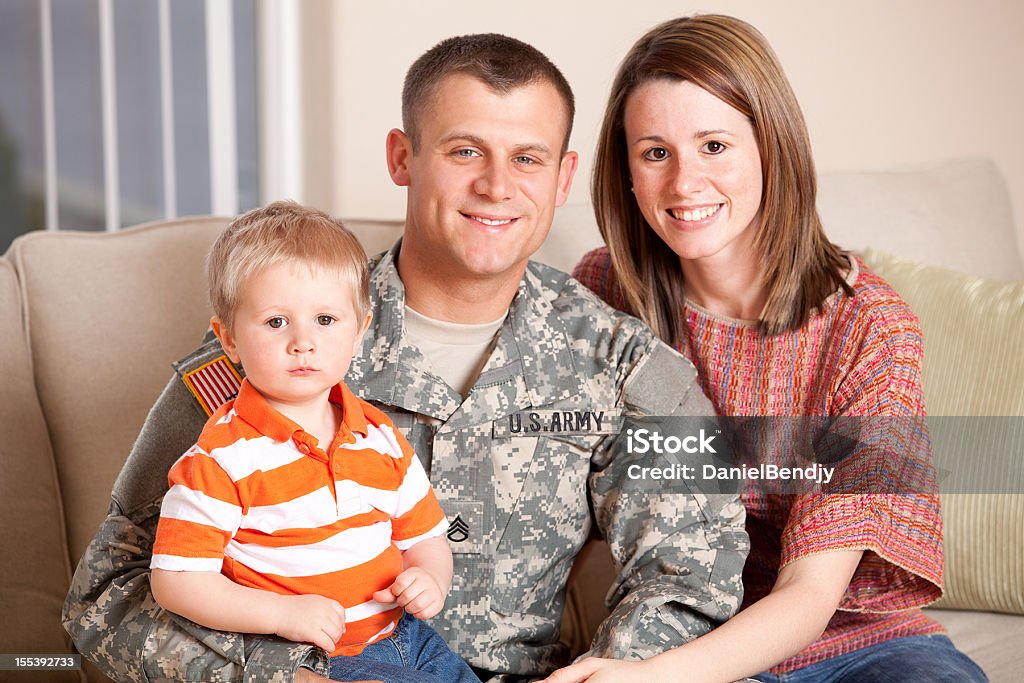 Army Family Series: Real American Soldier With Wife & Son Real American solider with wife and son indoor. Family Stock Photo