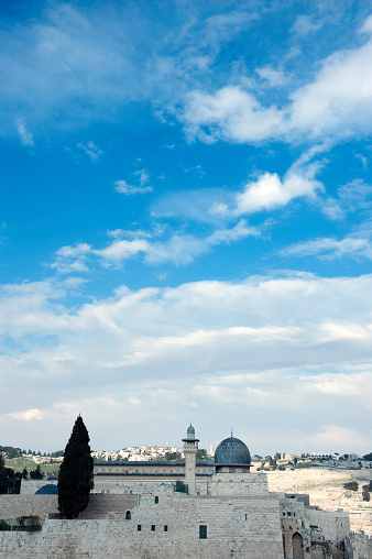 Mosque with large vertical space of clouds in the City of Jerusalem.