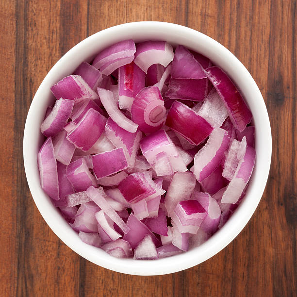 Diced red onion Top view of white bowl full of diced red onions chopped stock pictures, royalty-free photos & images