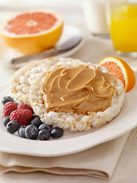 Rice Cakes Topped with Peanut Butter and Blueberries, Raspberries on the side with Grapefruit, Milk and Orange Juice- Photographed on Hasselblad H3D2-39mb Camera