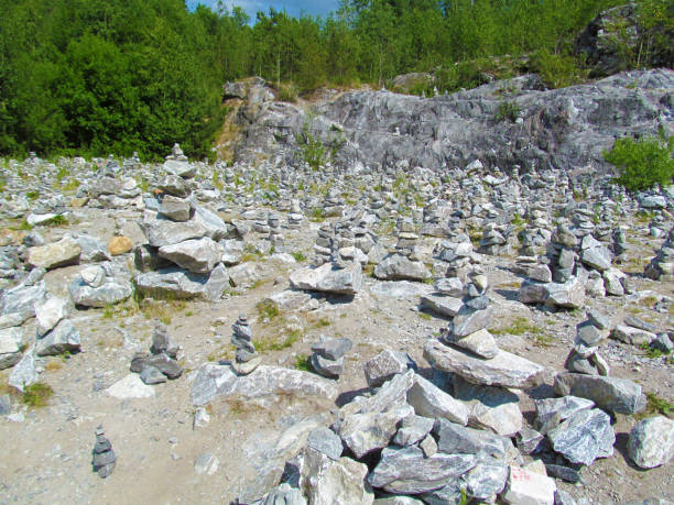 istock Stone area with small stone pyramids made by tourists - is a popular place in forest park. 1553930556