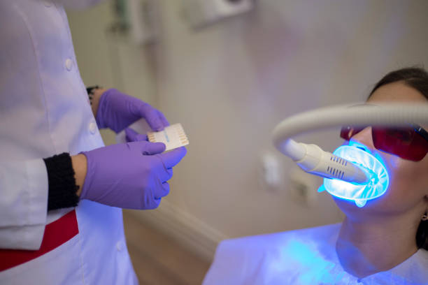 istock Dentistry dentist working teeth whitening dental medical process 1553933521
