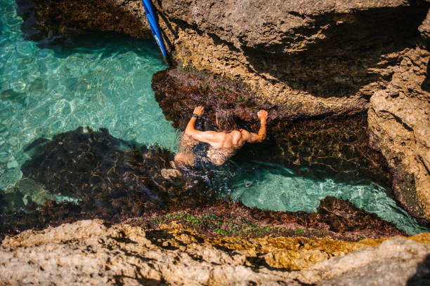 istock Climbing rocks above the sea 1553934036