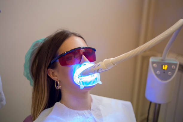 istock Dentistry dentist working teeth whitening dental medical process 1553934619