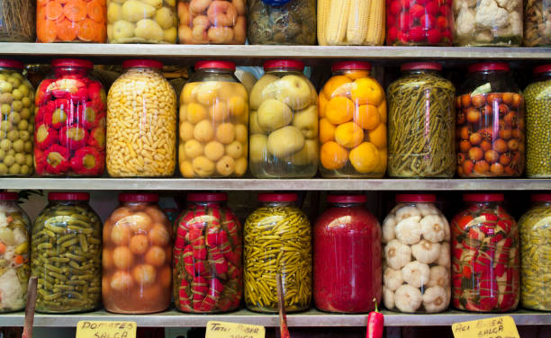 istock Jars of preserved vegetables on shelves 155393619