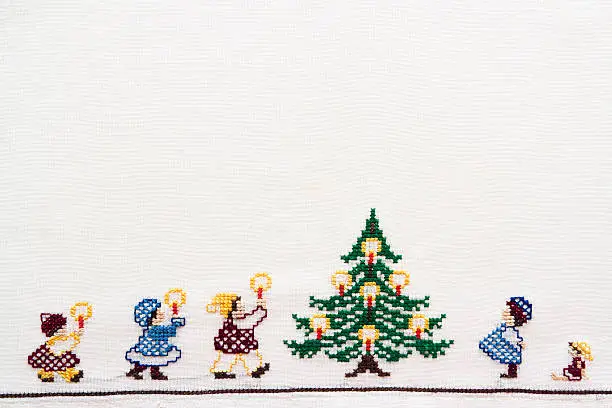 Children coming to the christmas tree, handmade cross-stitch embroidery full frame horizontal composition with copy space