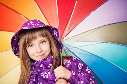 Portrait of a little girl with colorful umbrella.