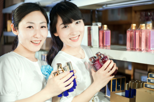 The east asian sisters enjoy buying cosmetics in a cosmetic store