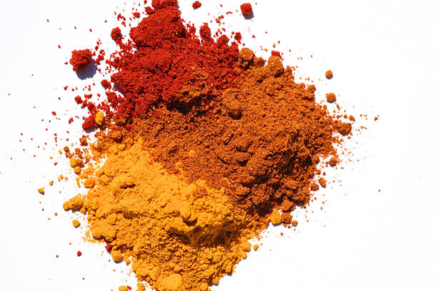 Three different powdered spices in a white background stock photo