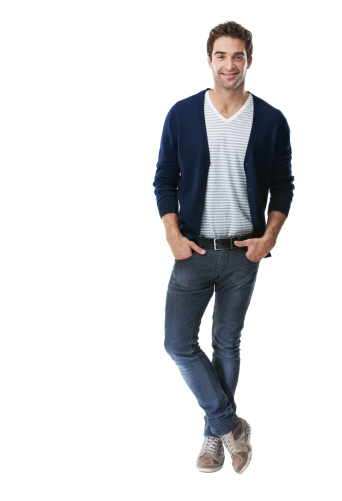 A handsome, trendy young man with his hands in his pockets isolated on white - Copyspace