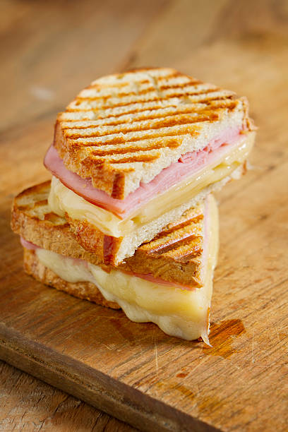 Panini Sandwiches Hot off the grill panini sandwiches made with crusty, hand sliced bread, black forest ham and swiss cheese. ham and cheese sandwich stock pictures, royalty-free photos & images