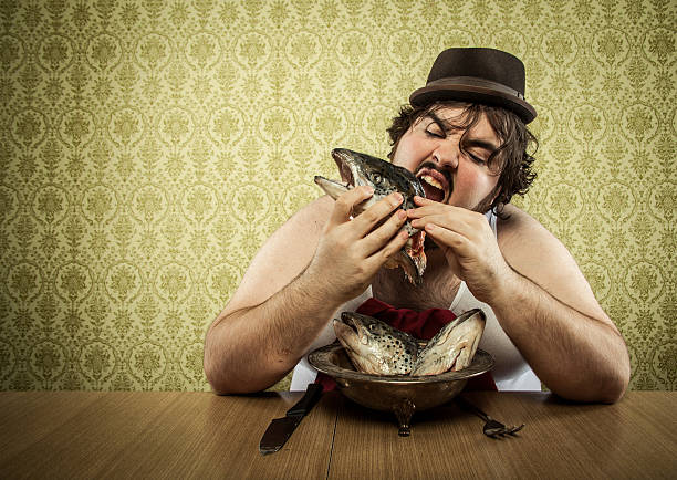 istock starving fat man eating fish head soup at wood table 155394504