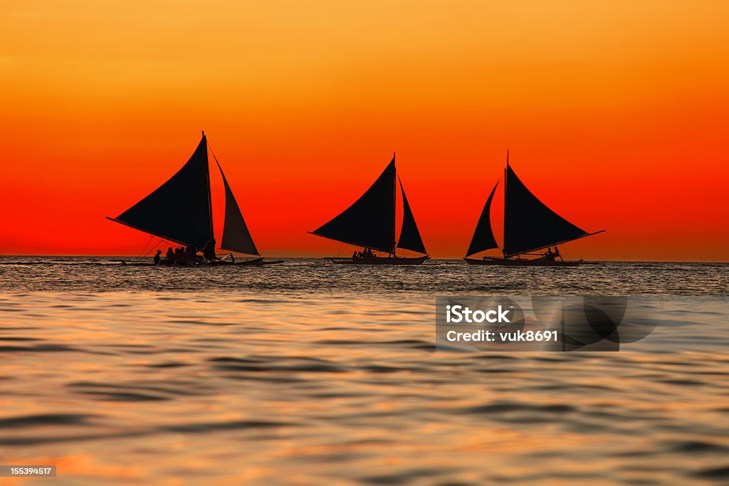 Sailing at sunset Sailing at sunset, Boracay island, Philippines Sailboat Stock Photo