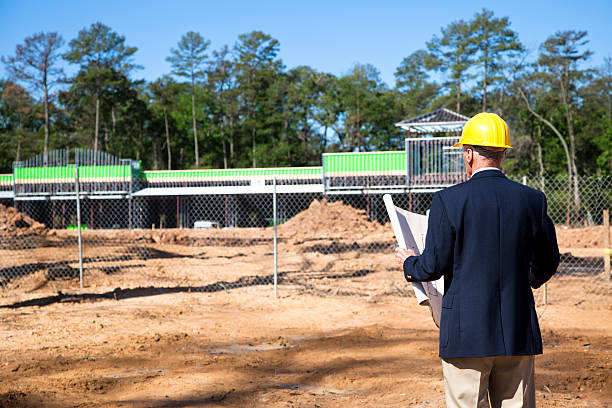 New commercial building construction site with contractor in foreground