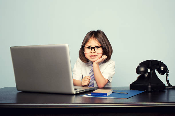 istock Young Girl Dressed in Tie at Laptop in Office 155394762