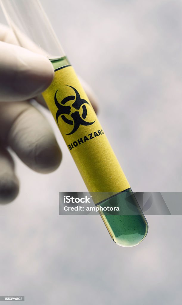 Biohazard Hand holding a test tube with biohazard symbol. Biochemical Weapon Stock Photo