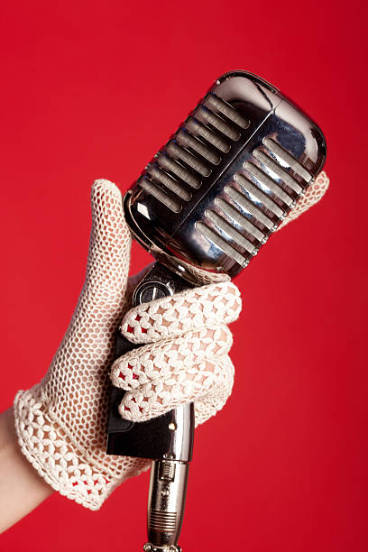 una mano con micrófono vintage - gloved hand fotografías e imágenes de stock