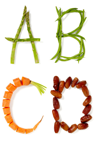 A, B, C and D made from foods starting with corresponding letters: asparagus, beans, carrot and dates, isolated on white background.  Part of entire food alphabet, larger files include clipping path.  Exported at 16 bit, color corrected and retouched for maximum image quality.