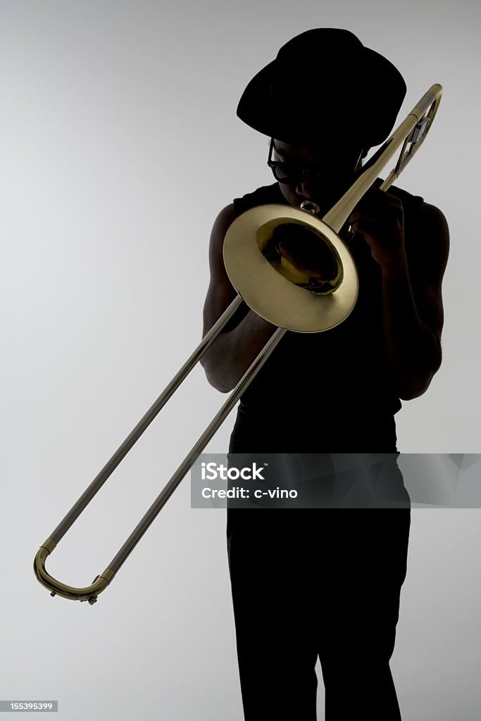 Silhouette of a man with sunglasses playing the trombone Jazz musician play of trombone Improv Stock Photo