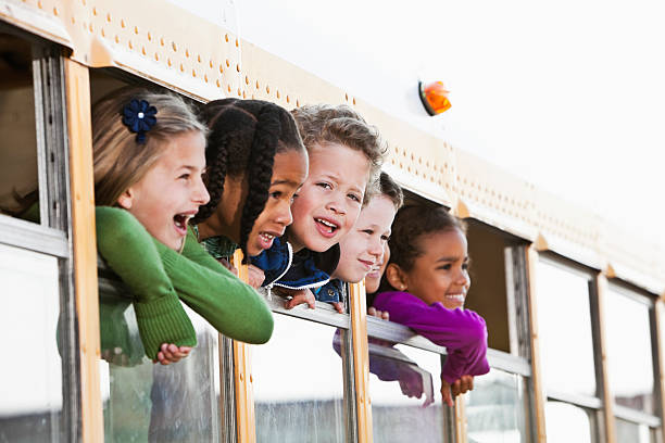 istock Children looking out school bus window 155395470