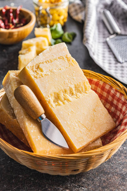 istock Tasty parmesan cheese in basket. 1553954930