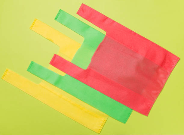 istock Biodegradable bags on color background, top view 1553956526