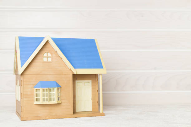 istock Model of house on wooden table 1553956529