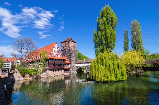 The half-timbered Weinstadl (engl: Wine store) and the  Hangman's Bridge (Henkersteg) in Nuremberg on a beautiful spring day.