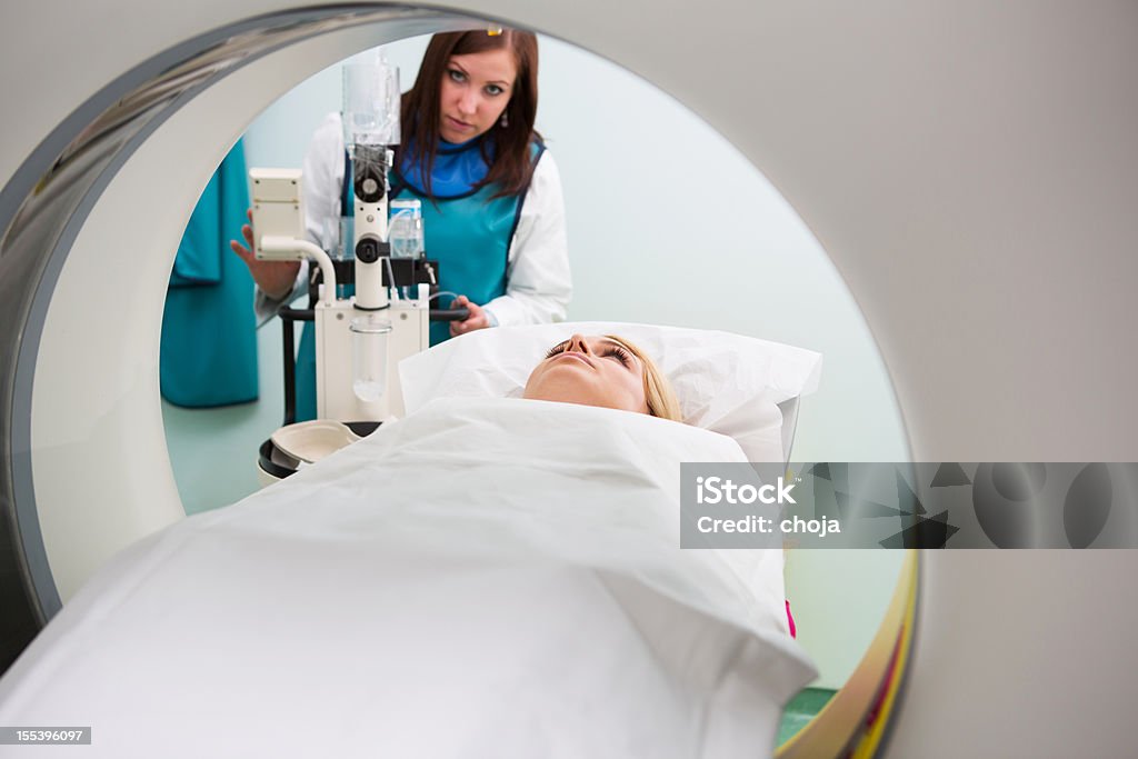 Young woman waiting for CAT scan with contrast  Adult Stock Photo