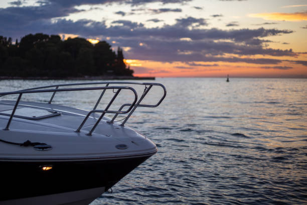 motorboat parked next do island at sunset