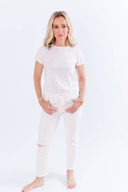 istock Blonde woman sitting against white background 1553972590