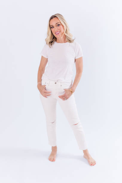 istock Blonde woman sitting against white background 1553972592