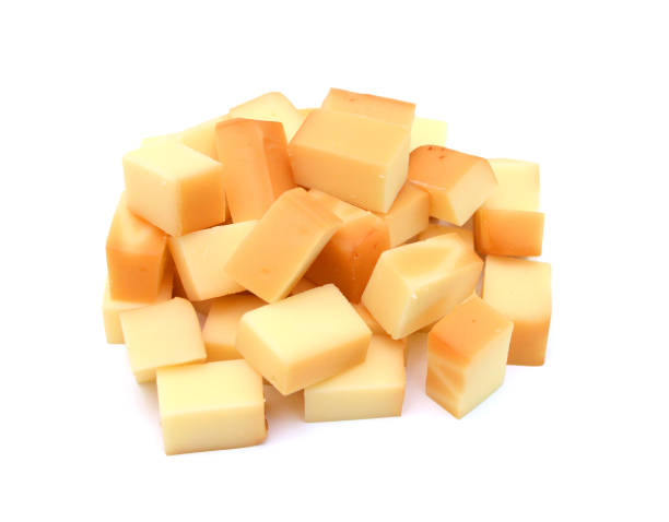 istock Cubes of cheddar cheese isolated on white 1553988891