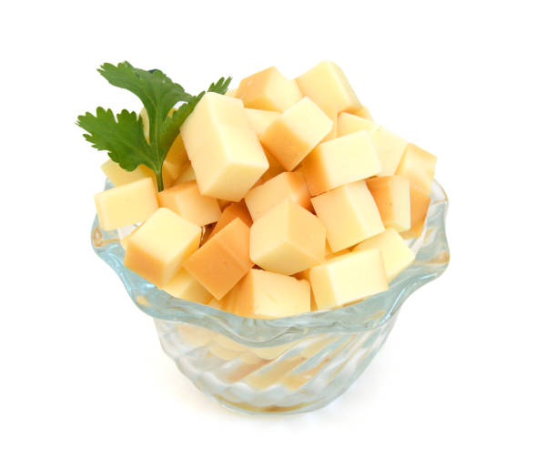 Cubes of cheddar cheese isolated on white Cubes of cheddar cheese isolated on white colby cheddar stock pictures, royalty-free photos & images