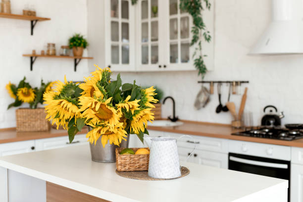 istock Vase with beautiful yellow sunflowers in the kitchen 1554005831
