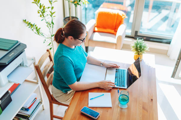 istock Mature woman working from home 1554006741