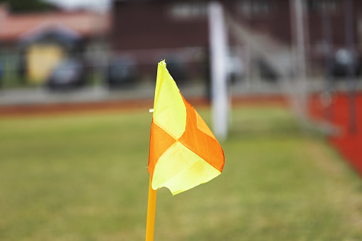 Red and yellow corner flag on a pitch