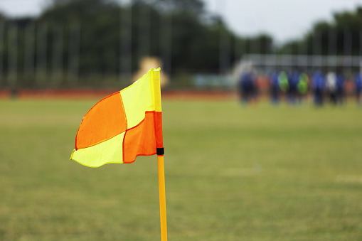 Red and yellow corner flag on a pitch