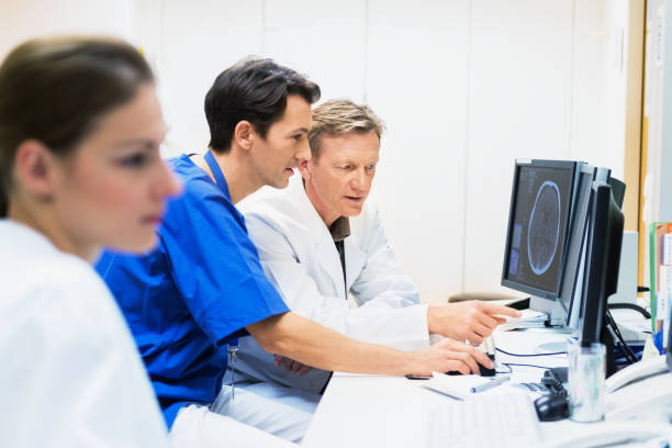 istock Doctors Discussing CAT Scans on Monitor 155401580